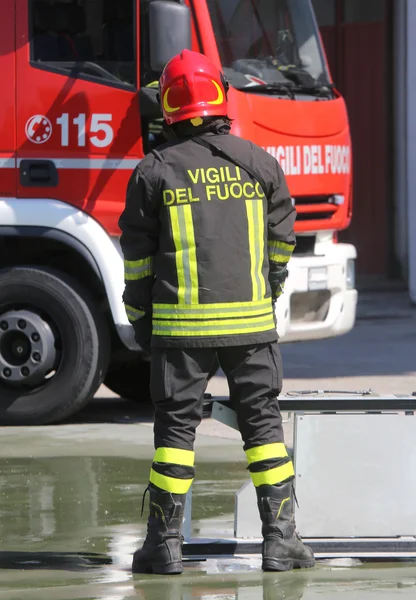 Isolated Italian fireman with protective uniform and helmet on h