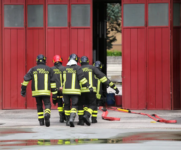 Wounded person carried by firefighters on a stretcher