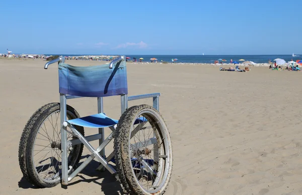 Wheelchair aluminum on the sand of the beach