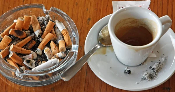 Cup of coffee espresso and ashtray chock