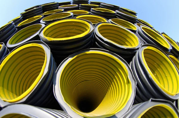 Yellow corrugated pipes in a roadworks for laying optical fiber