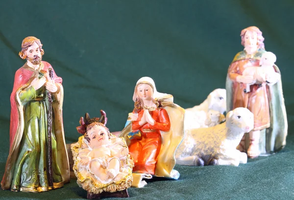 Mary and Joseph with the child Jesus in the manger with a shephe