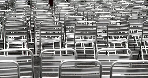 Steel chairs without viewers into an open-air cinema