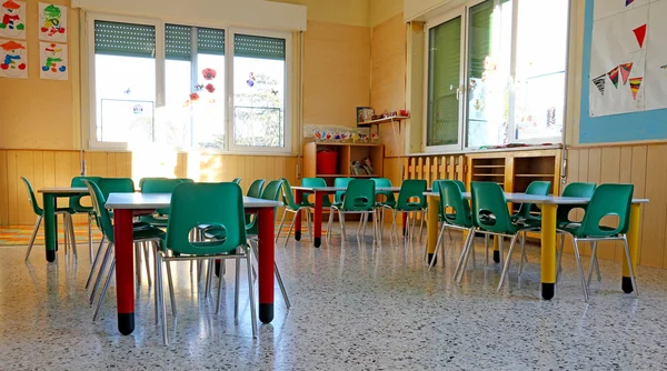 Interiors of a kindergarten class with the chairs and children\'s