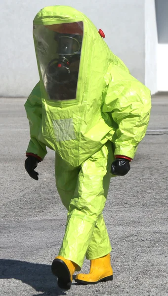 Person with yellow protective suit to manage hazardous materials