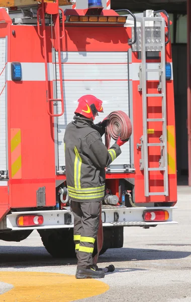 Firefighter lifted the hose after switching off the fire