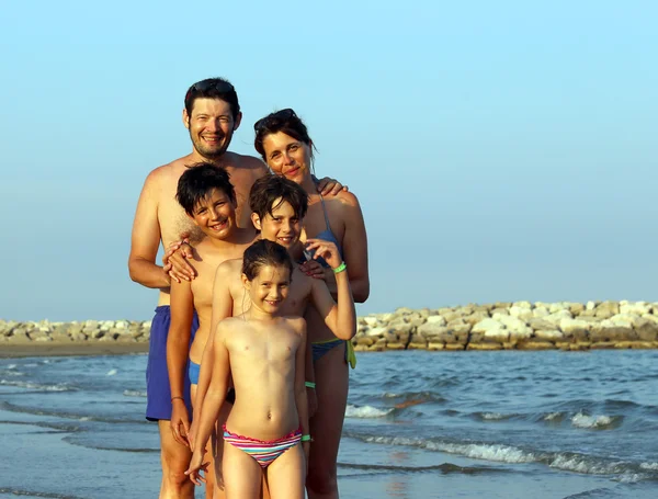 Happy Family of five people on the beach