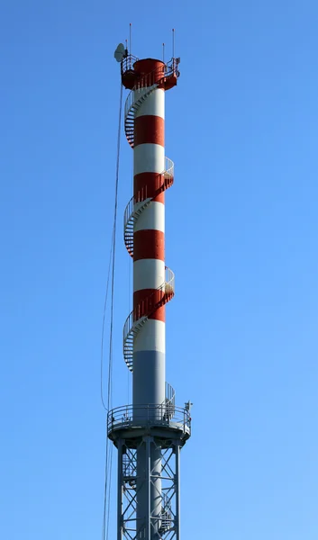 Highest red and white smokestack with the antennas