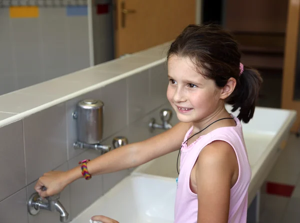 Little girl is washing her hands