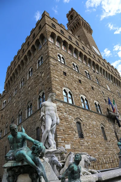 White statue of Neptune in the ancient fountain in Florence and