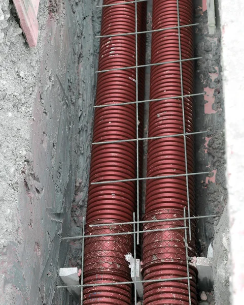 Thick polyethylene pipes in the excavation of the road construct