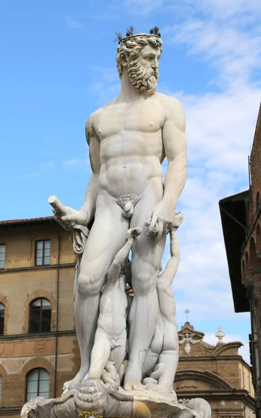 White statue of Neptune in the ancient fountain in Florence