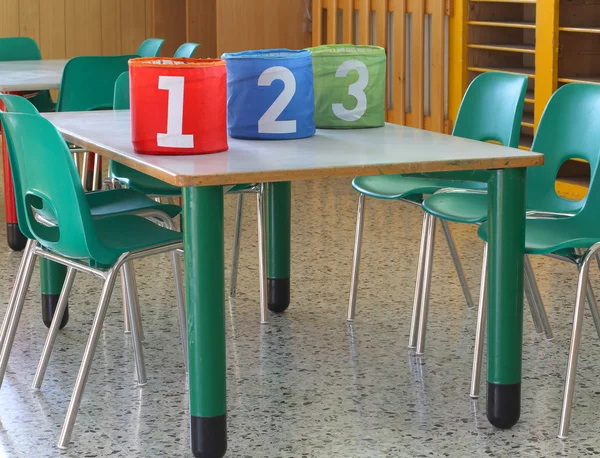 Bins with large numbers on the desk in the kindergarten