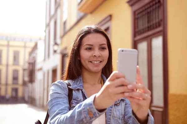 Pretty young girl taking a vertical picture