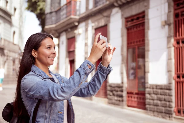 Girl tourist taking picture with cellphone