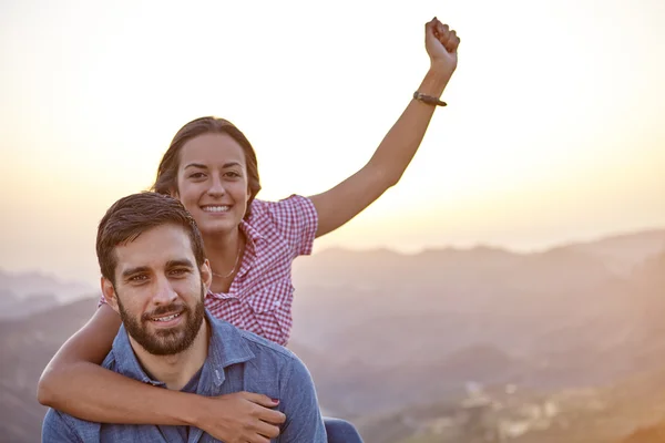 Celebrating young couple on mountain top