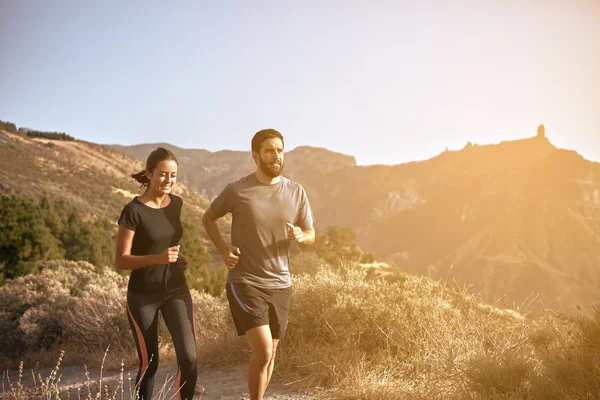 Young couple running in mountains