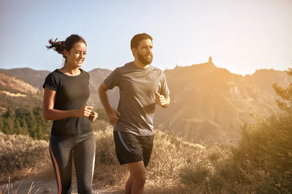 Young couple running in mountains