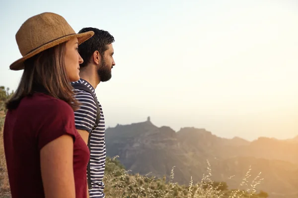 Young couple looking over mountains