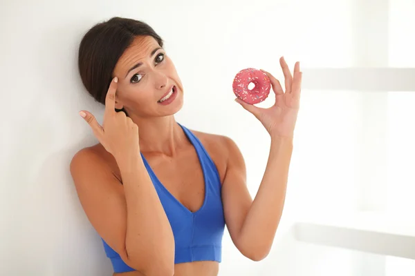 Young woman in exercising clothes choosing food