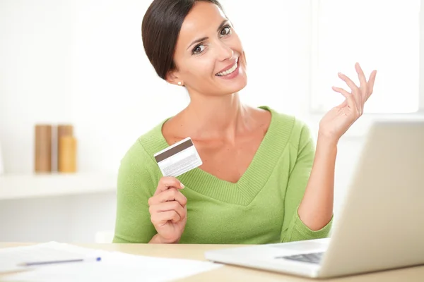 Smiling young woman buying on e-commerce from home