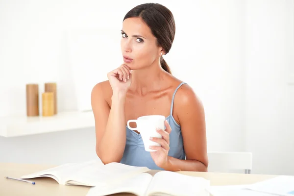 Adult beautiful woman wondering while studying