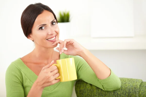 Smiling woman with yellow mug