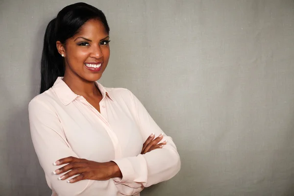 Professional woman smiling with arms crossed