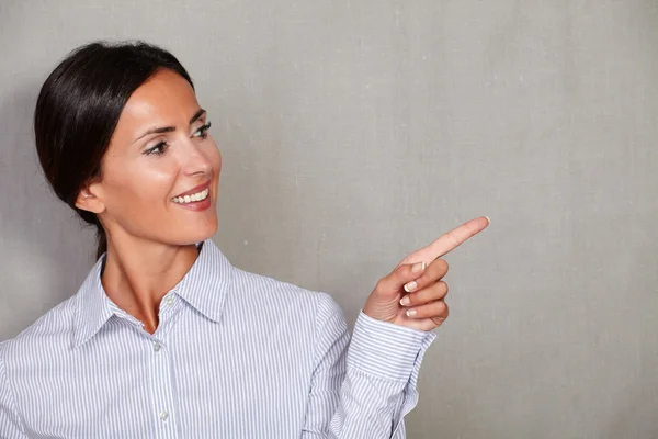 Businesswoman pointing to her left with finger