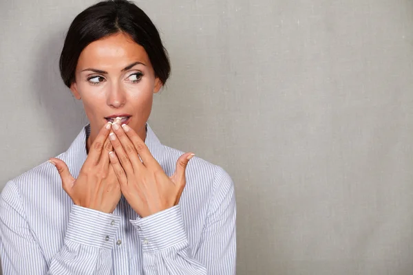 Female with hands to mouth gesture