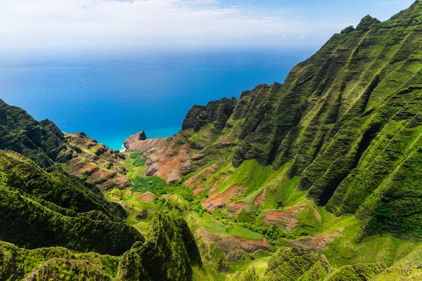 Aerial landscape view of cliffs and green valley, Kauai