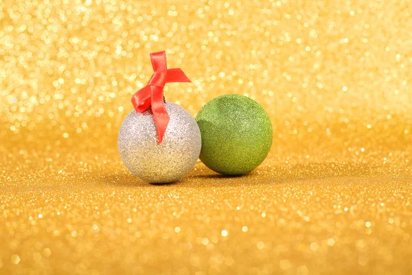 Christmas balls over gold glitter background with copy space