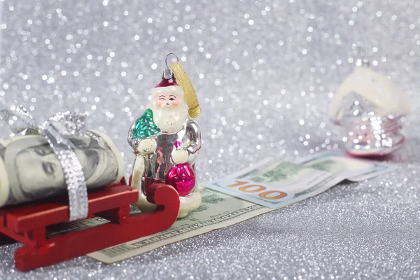 Santa with money on sledge