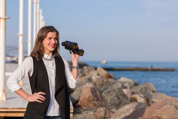 Business woman with a pair of binoculars