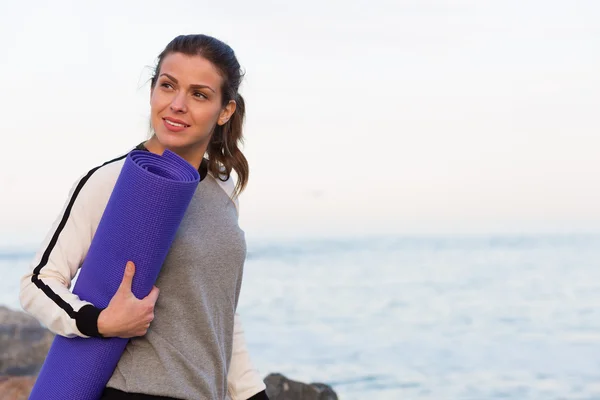 Sportive woman working out by the sea