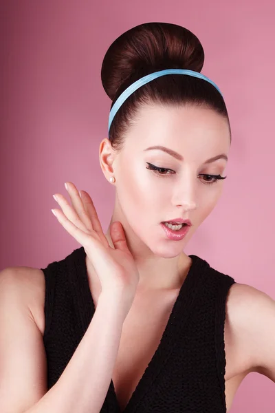 Portrait of young beautiful fresh slim girl with clean make-up and hair bun