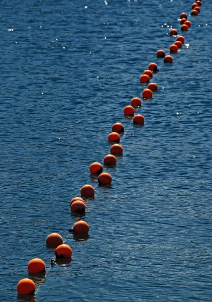 Red buoys on blue water suface on lake Sevan