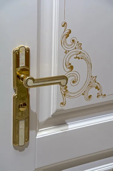 Classical style golden door handle with marble inlay on white door