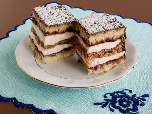 Coconut and cacao biscuit layer-cake with mas