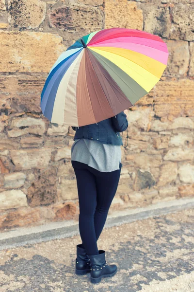 Girl holding a colorfull umbrella