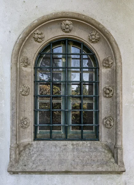 Antique vintage window. Decorated with stone carvings.