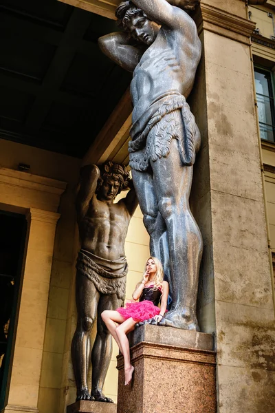 The young woman, the ballerina dances on the square