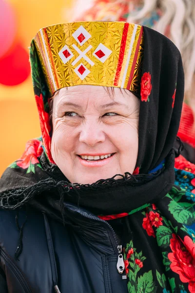 Close up of unknown beautiful aged woman in national folk clothe