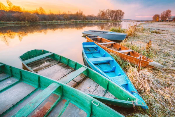 River and old rowing fishing boats at beautiful sunrise sunset