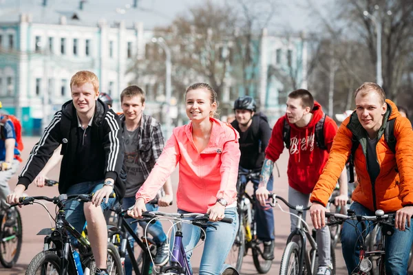 Group of people cyclists ride on street at opening of the cyclin