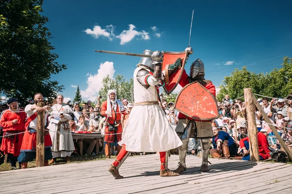 Knights In Fight With Swords. Restoration Of Knightly Battle