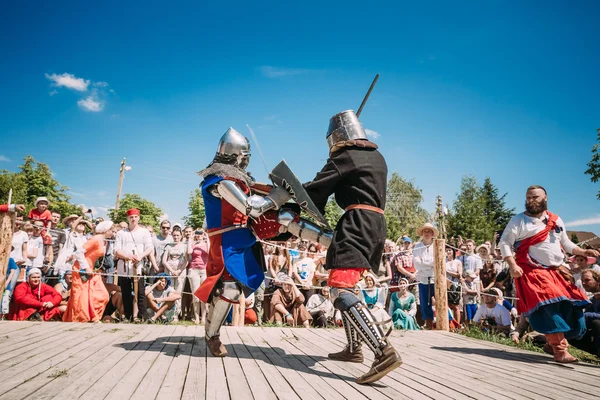 Knights In Fight With Swords. Restoration Of Knightly Battle