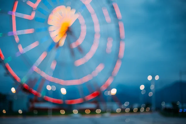 Abstract Blur Image Of Illuminated Ferris Wheel In Amusement Par