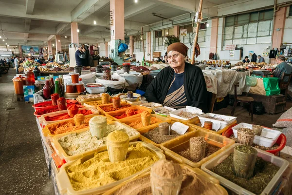Elderly Georgian Woman, Seller Of Spices Is Waiting For Buyers A