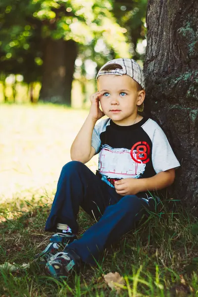 Happy Child Wearing Striped Cap In Outdoor Portrait
